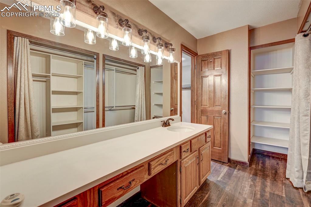 910 Fontmore Road, Unit B Colorado Springs, CO 80904 - Photo 18 of 32 a room with a wooden floor and a bathroom