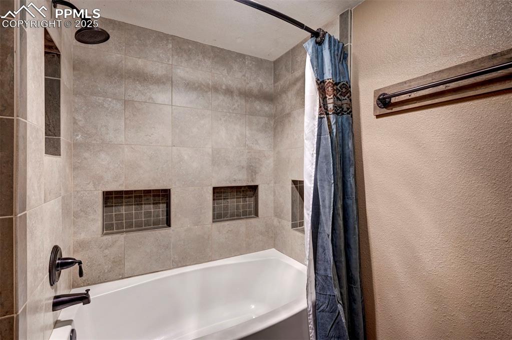 910 Fontmore Road, Unit B Colorado Springs, CO 80904 - Photo 21 of 32 a bathroom with a tub and a shower