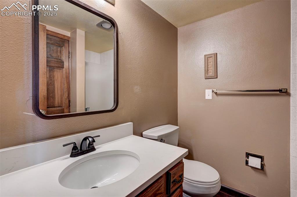 910 Fontmore Road, Unit B Colorado Springs, CO 80904 - Photo 22 of 32 a bathroom with a sink a toilet and mirror