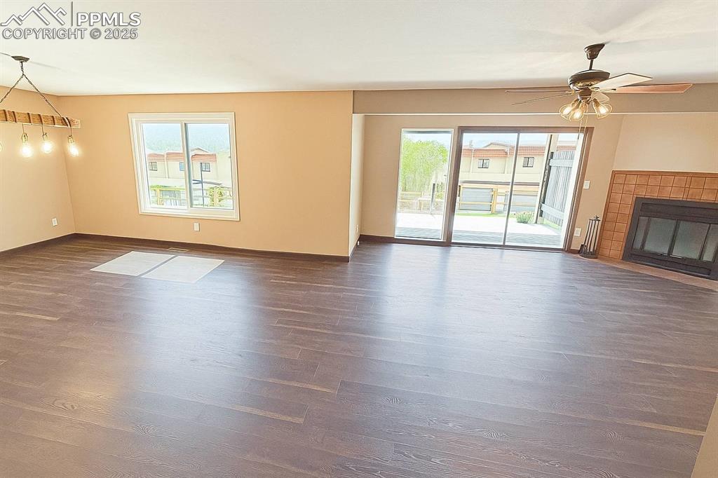 910 Fontmore Road, Unit B Colorado Springs, CO 80904 - Photo 4 of 32 a view of an empty room with a window and wooden floor