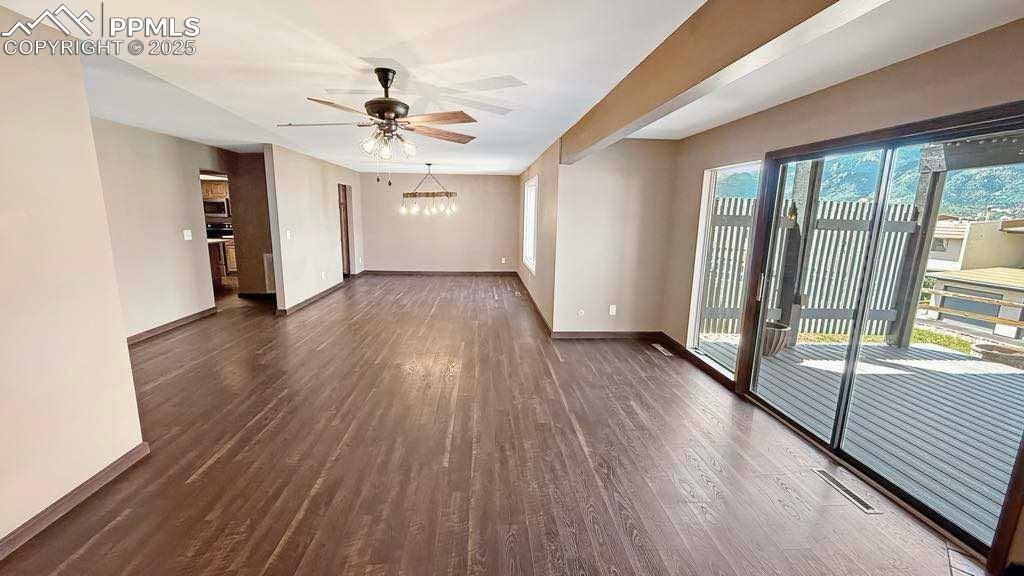 910 Fontmore Road, Unit B Colorado Springs, CO 80904 - Photo 5 of 32 a view of a livingroom with wooden floor and a ceiling fan
