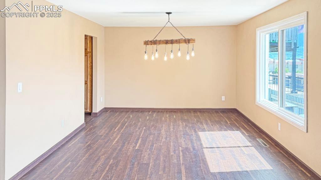 910 Fontmore Road, Unit B Colorado Springs, CO 80904 - Photo 6 of 32 a view of empty room with wooden floor and windows
