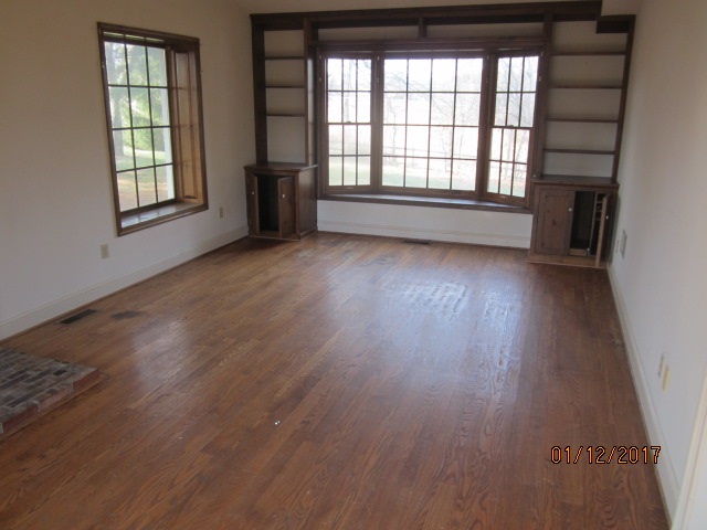 760 Buttermilk Spring Road Staunton, VA 24401 - Photo 3 of 20 an empty room with wooden floor and windows