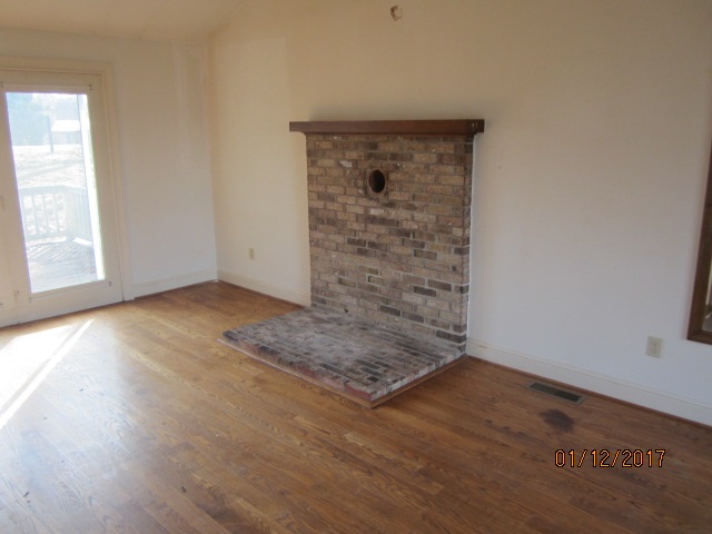 760 Buttermilk Spring Road Staunton, VA 24401 - Photo 4 of 20 an empty room with wooden floor and windows