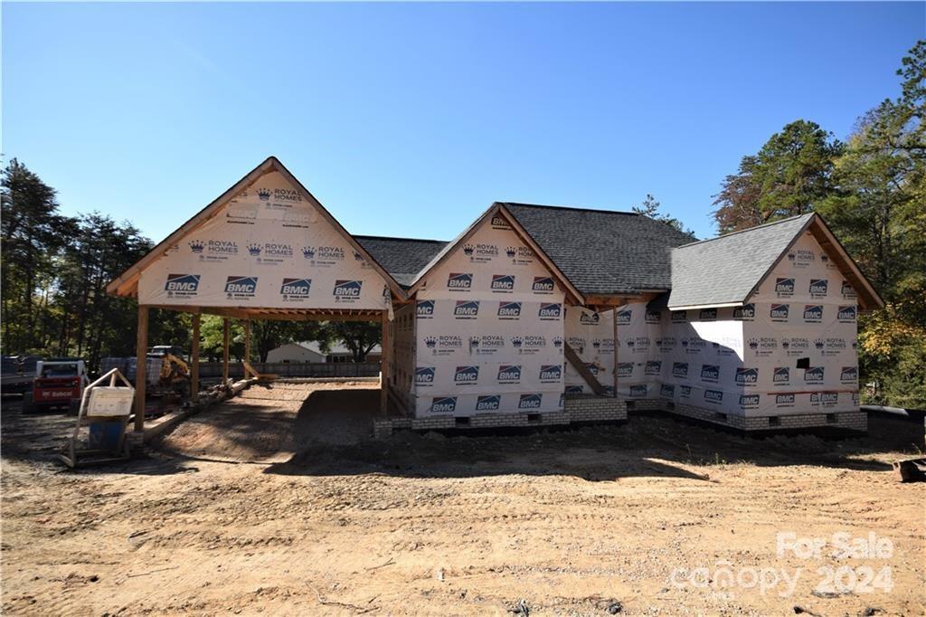a view of a house with a yard covered in snow