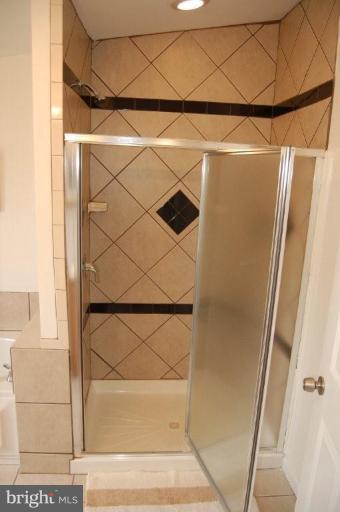 28 Crafton Road Essex, MD 21221 - Photo 9 of 13 a bathroom with a shower and a mirror