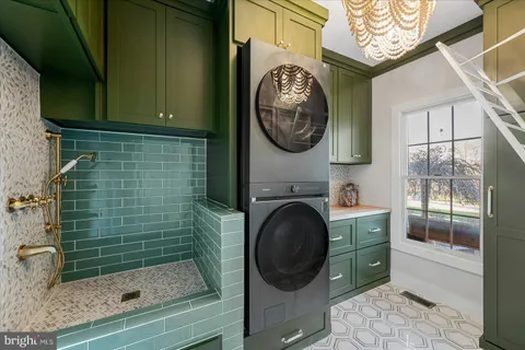 a kitchen with a white cabinets and window