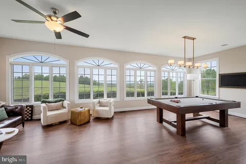 a bathroom with a toilet a sink a vanity and mirror