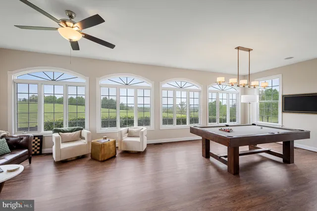 a hallway with white cabinets and wooden floor