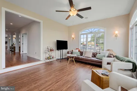 a living room with a bed furniture and a flat screen tv