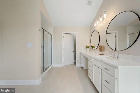 a bathroom with a sink a toilet and shower curtain