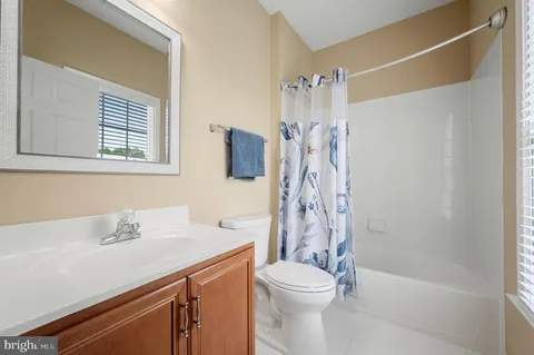 a bedroom with a large bed and windows