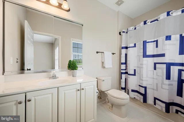 a front view of a house with a garden and patio