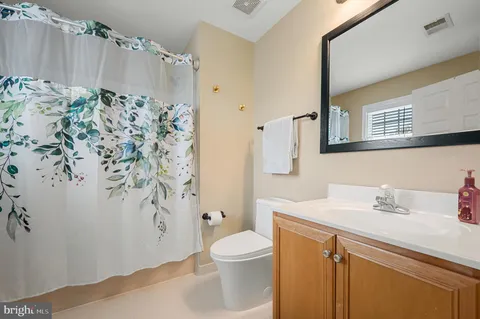 a front view of a house with a garden and patio