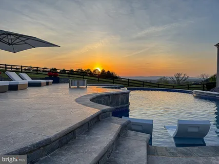 an aerial view of a house with garden space and lake view