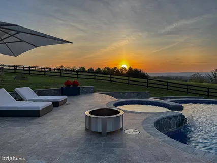 a view of a patio with a dining table and chairs with wooden floor