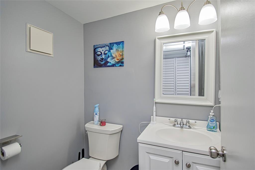 436 Fanshaw K, Unit 436 Boca Raton, FL 33434 - Photo 15 of 16 a bathroom with a sink mirror and toilet