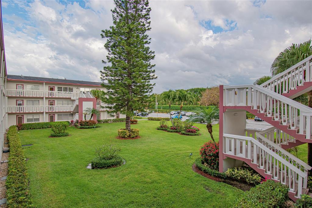 436 Fanshaw K, Unit 436 Boca Raton, FL 33434 - Photo 16 of 16 a view of an apartment with a garden and pathway
