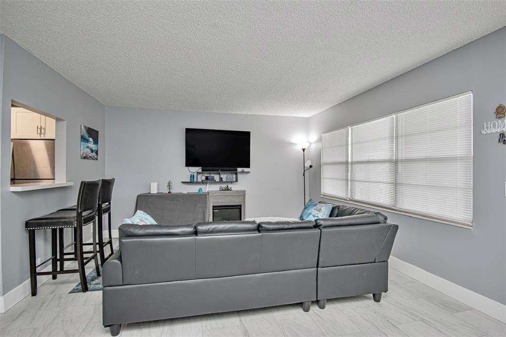 436 Fanshaw K, Unit 436 Boca Raton, FL 33434 - Photo 4 of 16 a room with furniture and flat screen tv