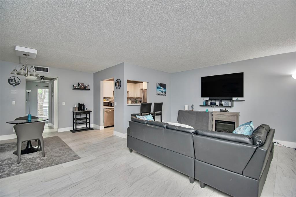 436 Fanshaw K, Unit 436 Boca Raton, FL 33434 - Photo 6 of 16 a living room with furniture and a flat screen tv