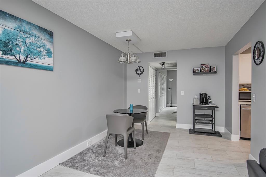 436 Fanshaw K, Unit 436 Boca Raton, FL 33434 - Photo 7 of 16 a living room with furniture and a chair