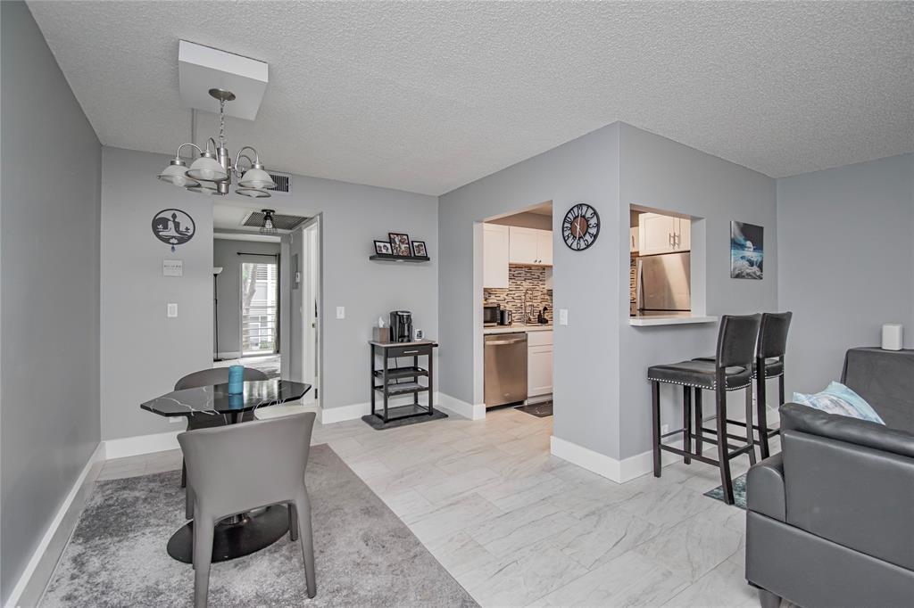 436 Fanshaw K, Unit 436 Boca Raton, FL 33434 - Photo 9 of 16 a living room with furniture and view of kitchen