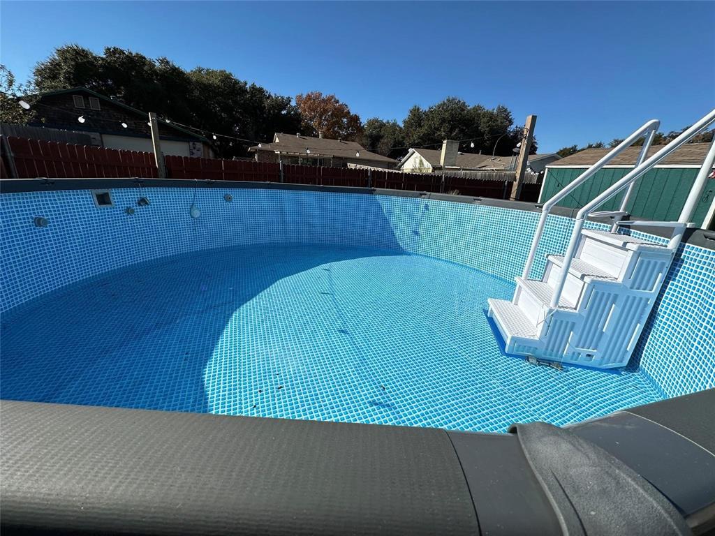 4601 Elm Ridge Lane Garland, TX 75044 - Photo 19 of 21 Above-ground pool with blue patterned liner and white plastic entry steps