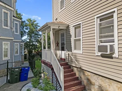 a view of a house with more windows and flower plants