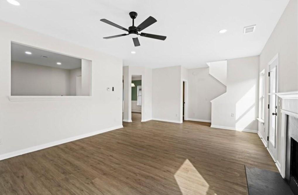 4095 Arch Pass Cumming, GA 30040 - Photo 11 of 31 a view of a livingroom with a ceiling fan and wooden floor