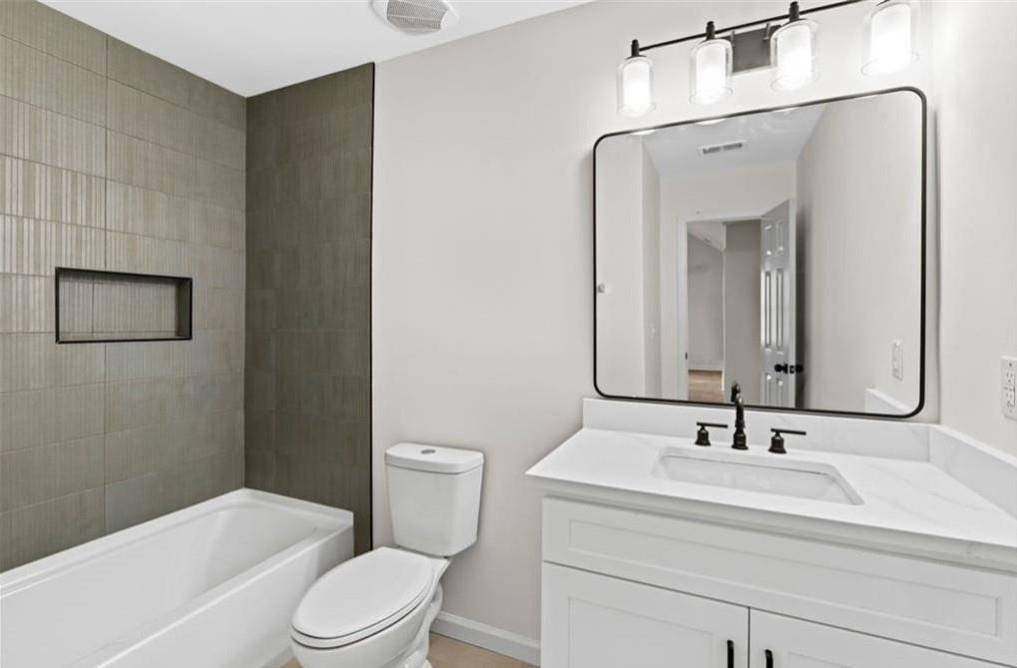 4095 Arch Pass Cumming, GA 30040 - Photo 17 of 31 a bathroom with a sink a toilet and shower