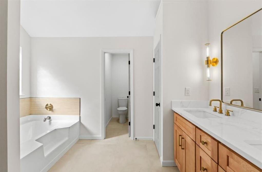 4095 Arch Pass Cumming, GA 30040 - Photo 25 of 31 a spacious bathroom with a tub sink and mirror