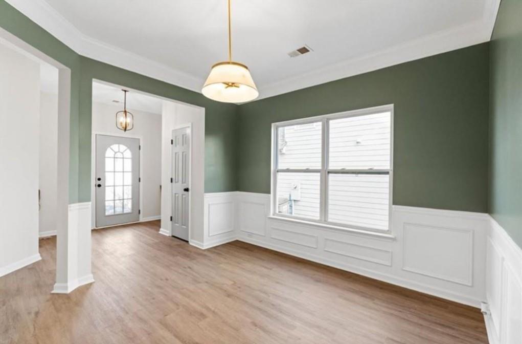 4095 Arch Pass Cumming, GA 30040 - Photo 6 of 31 a view of an empty room with wooden floor and a window