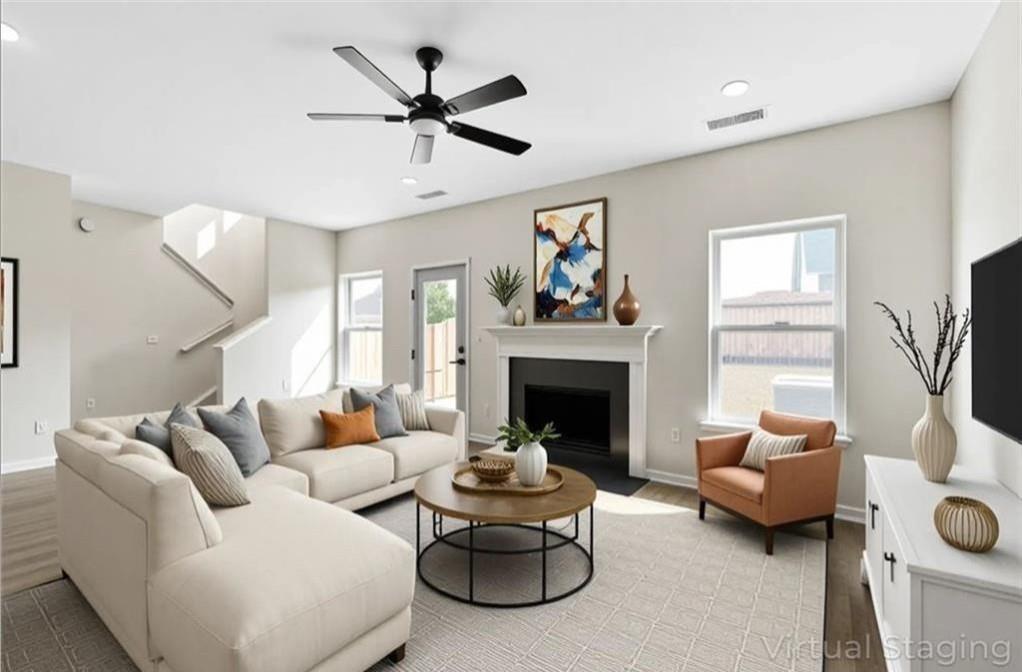 4095 Arch Pass Cumming, GA 30040 - Photo 9 of 31 a living room with furniture and a fireplace