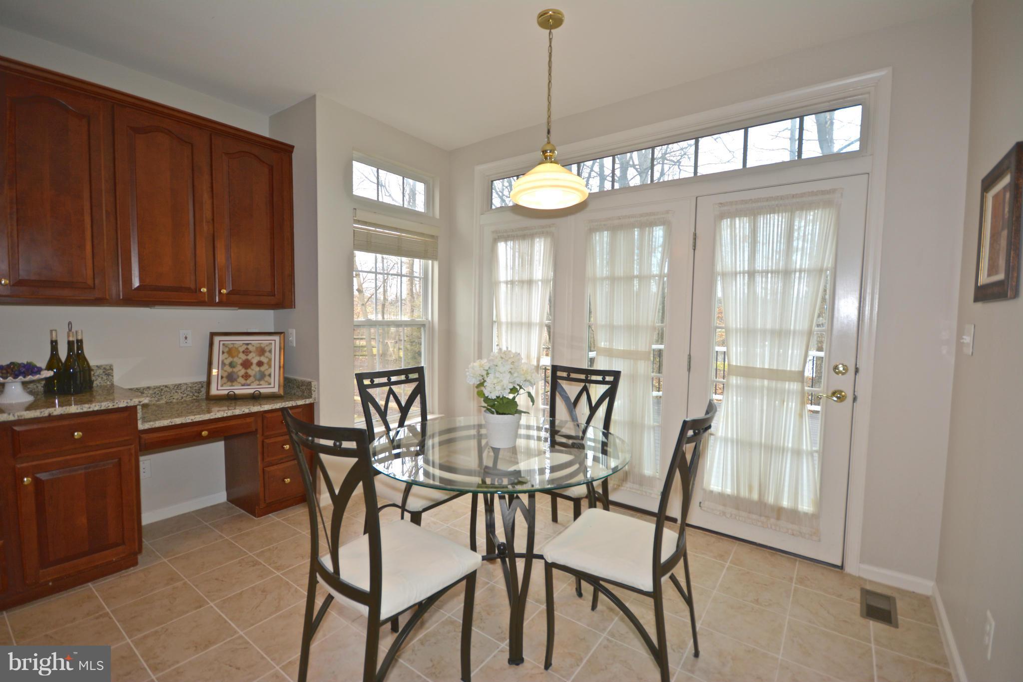 14468 Clubhouse Road Gainesville, VA 20155 - Photo 12 of 30 a view of a dining room with furniture window and wooden floor
