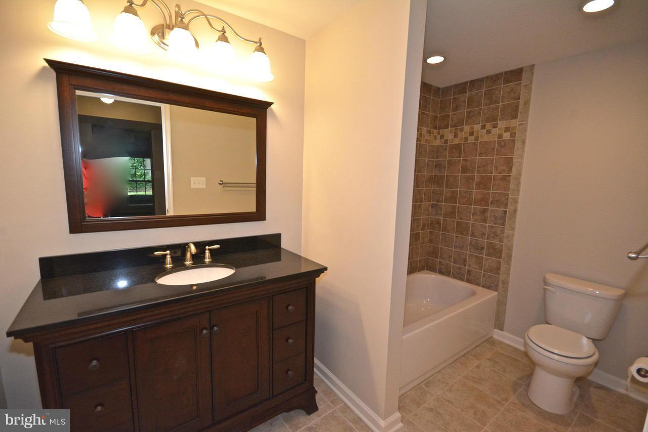14468 Clubhouse Road Gainesville, VA 20155 - Photo 24 of 30 a bathroom with a sink a toilet and shower