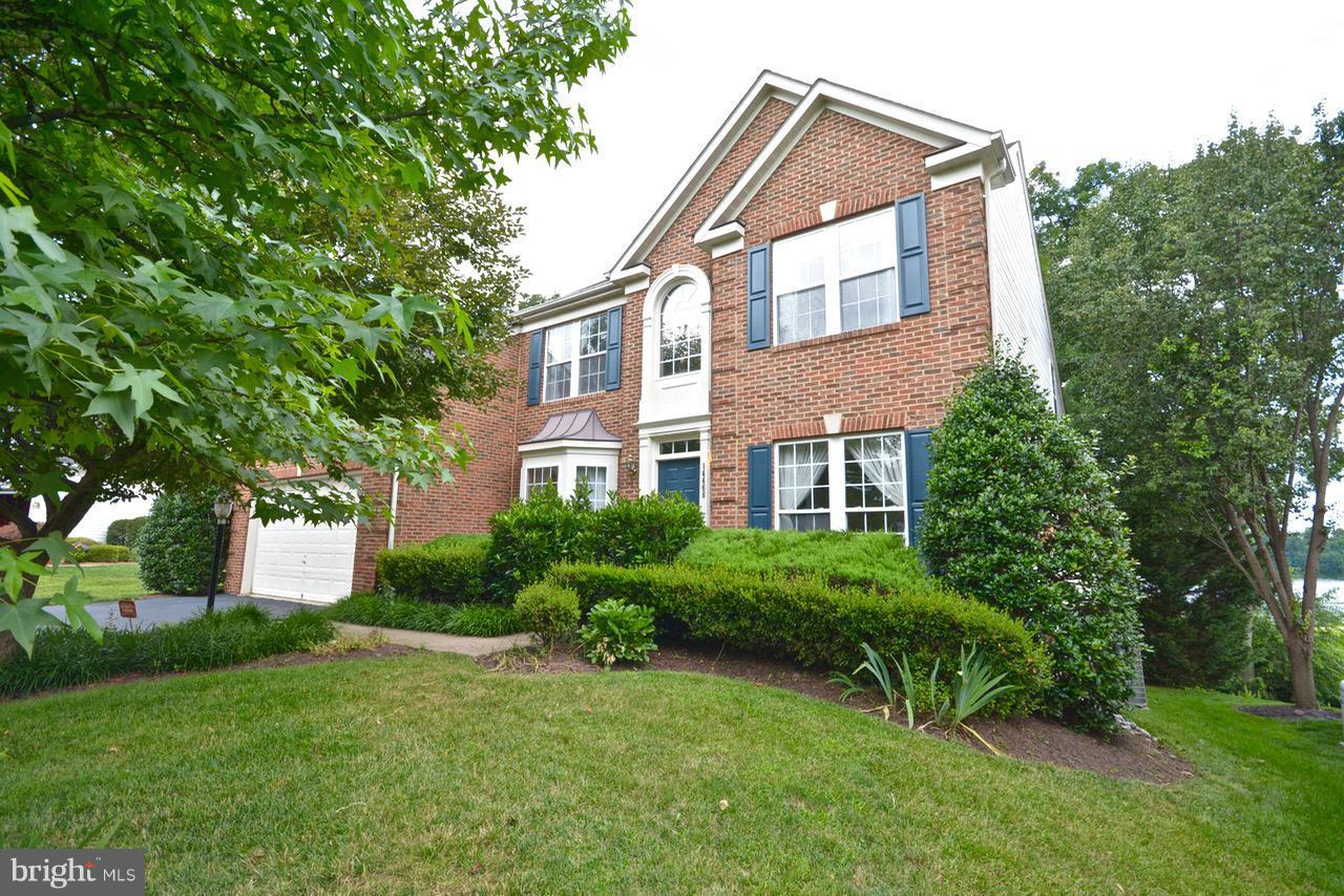 14468 Clubhouse Road Gainesville, VA 20155 - Photo 27 of 30 a front view of a house with a yard and trees