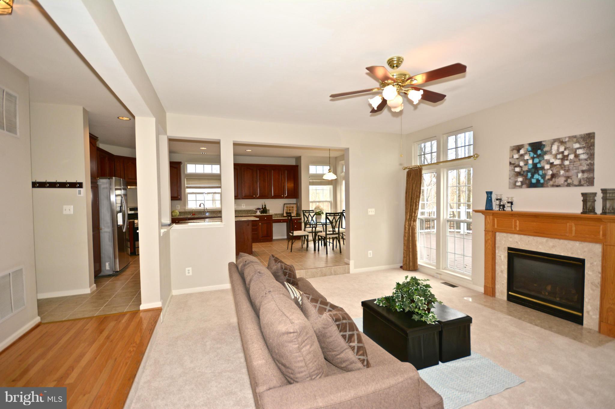 14468 Clubhouse Road Gainesville, VA 20155 - Photo 8 of 30 a living room with furniture chandelier and a fireplace