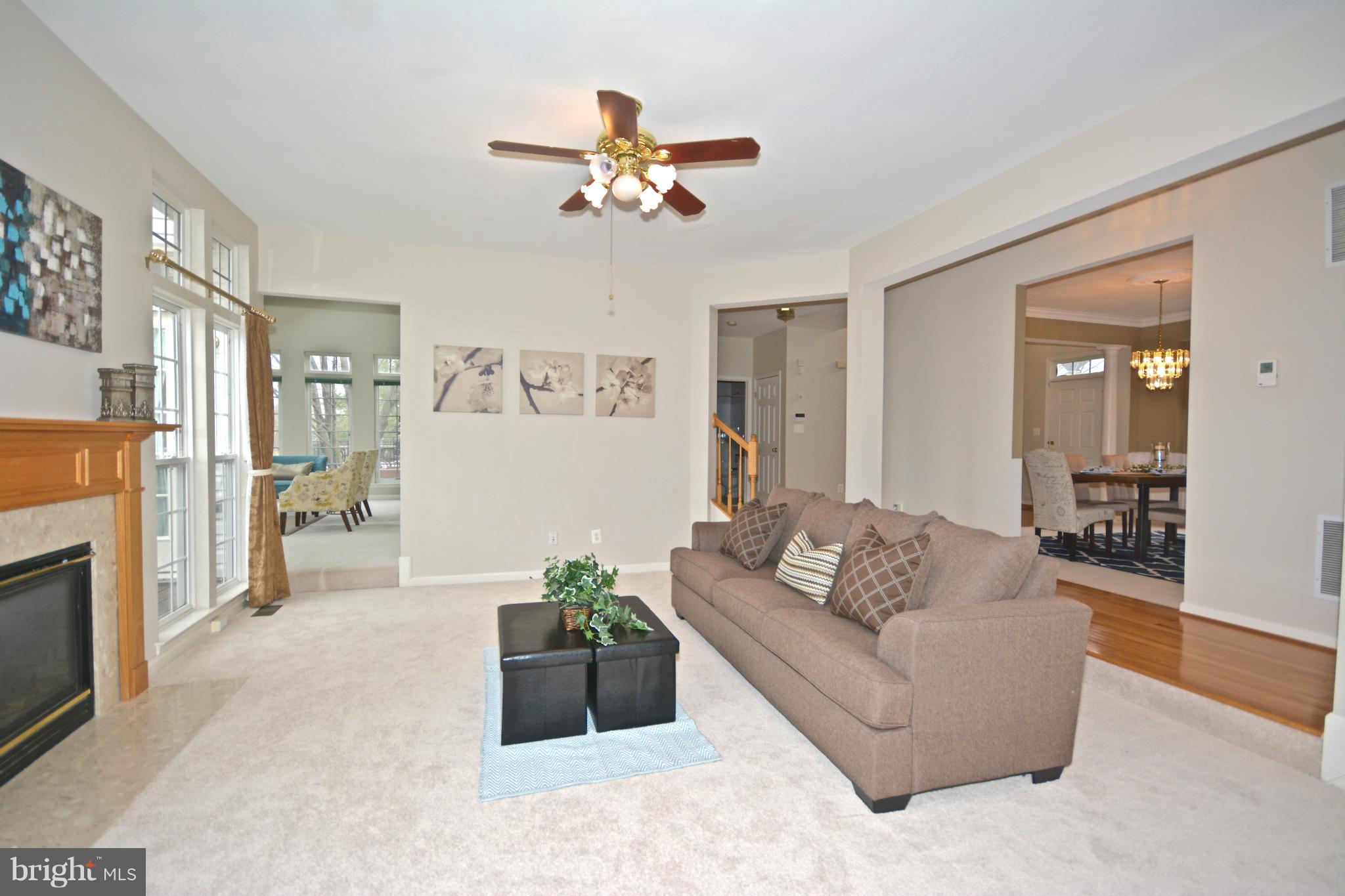 14468 Clubhouse Road Gainesville, VA 20155 - Photo 9 of 30 a living room with furniture and a chandelier