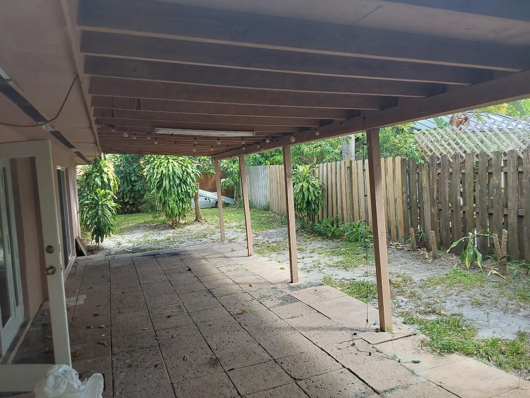 98 Seminole Lane Boca Raton, FL 33487 - Photo 42 of 42 a backyard of a house with plants and outdoor seating