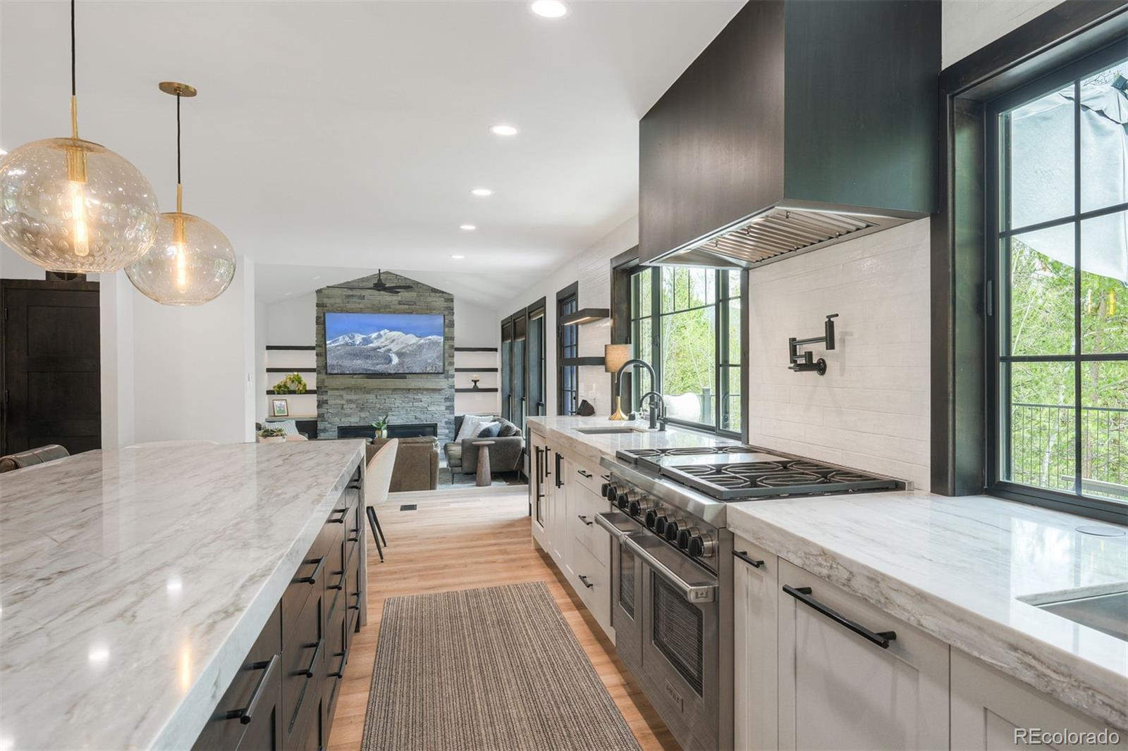 306 Golden Eagle Road Silverthorne, CO 80498 - Photo 10 of 43 a kitchen with stainless steel appliances granite countertop a stove and a large window