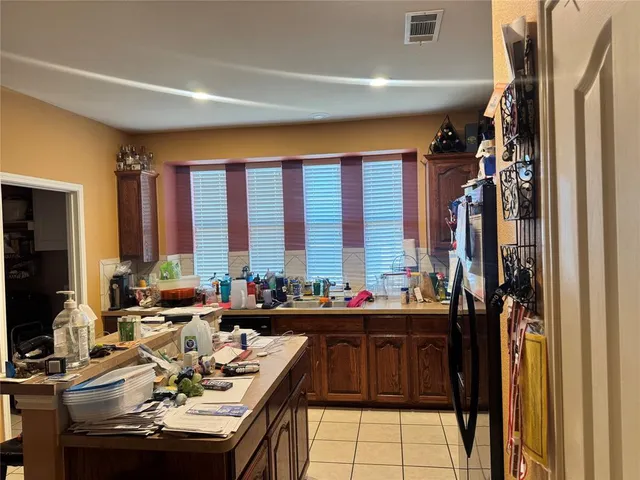 a dining room with furniture and large windows