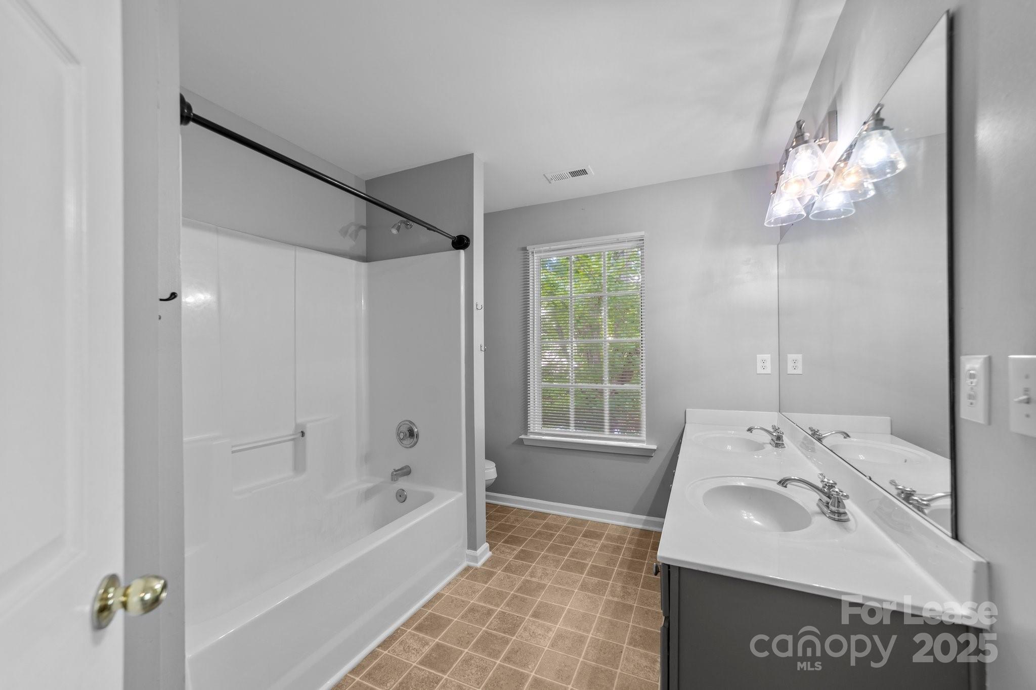 17562 Caldwell Track Drive Cornelius, NC 28031 - Photo 18 of 38 a bathroom with a sink a toilet and shower