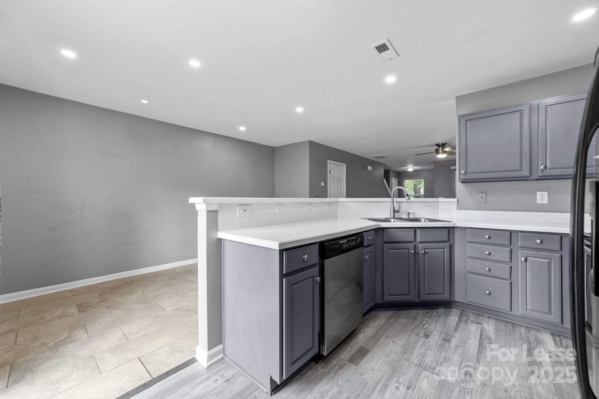17562 Caldwell Track Drive Cornelius, NC 28031 - Photo 2 of 38 a kitchen with a sink cabinets and wooden floor