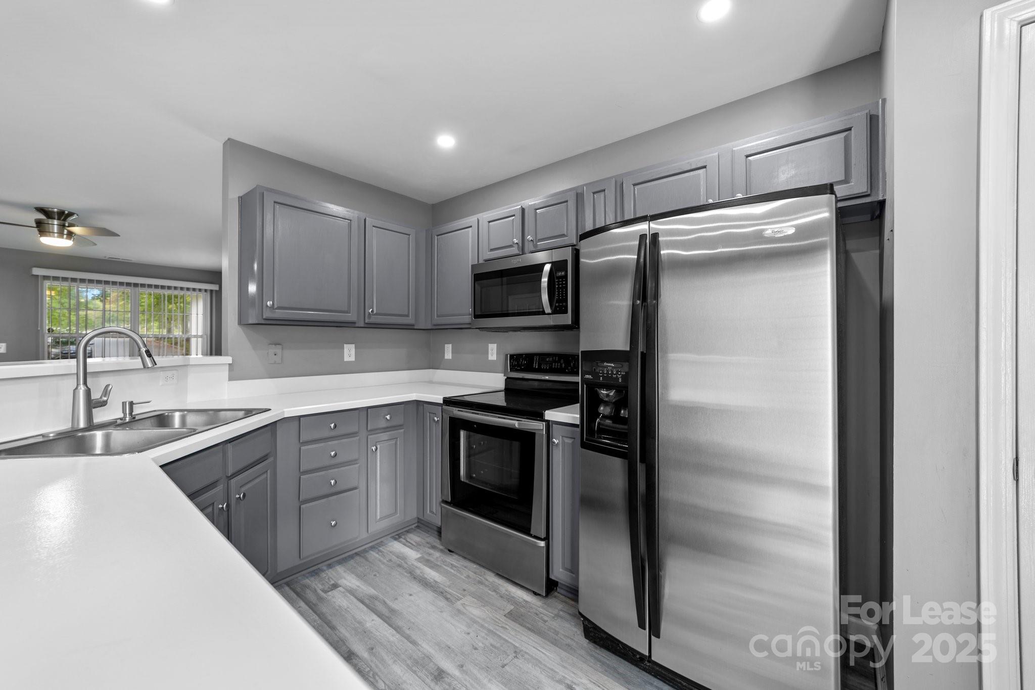 17562 Caldwell Track Drive Cornelius, NC 28031 - Photo 3 of 38 a kitchen with a refrigerator stove and sink