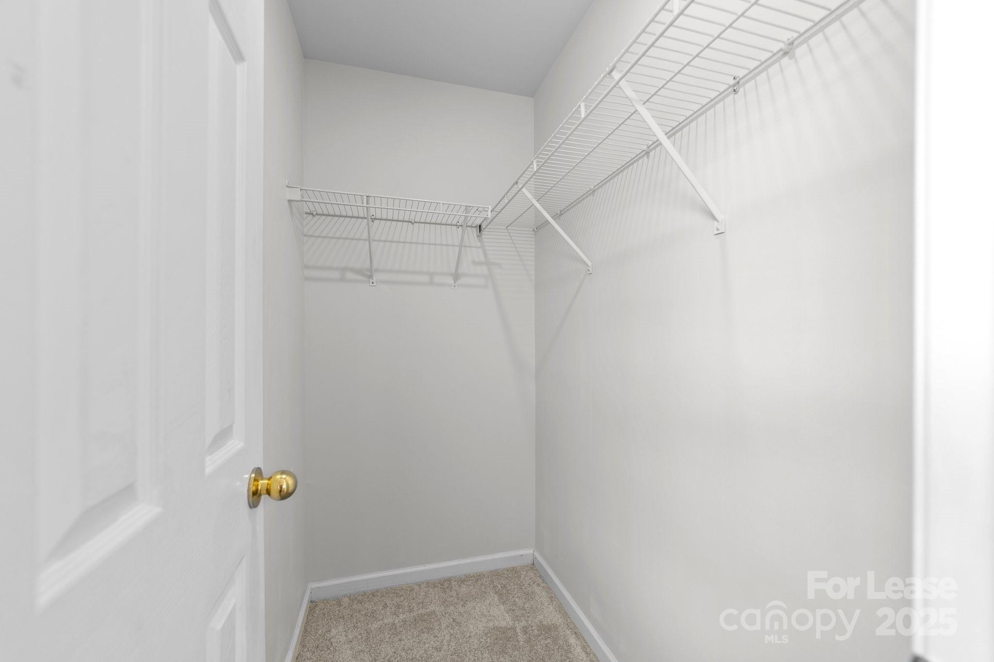 17562 Caldwell Track Drive Cornelius, NC 28031 - Photo 31 of 38 a view of walk in closet with clothes