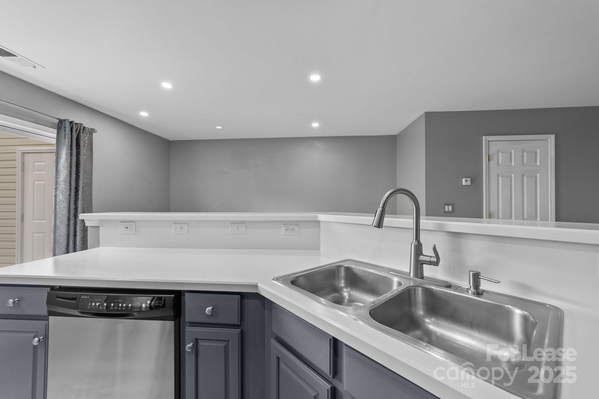 17562 Caldwell Track Drive Cornelius, NC 28031 - Photo 4 of 38 a kitchen with a sink and cabinets