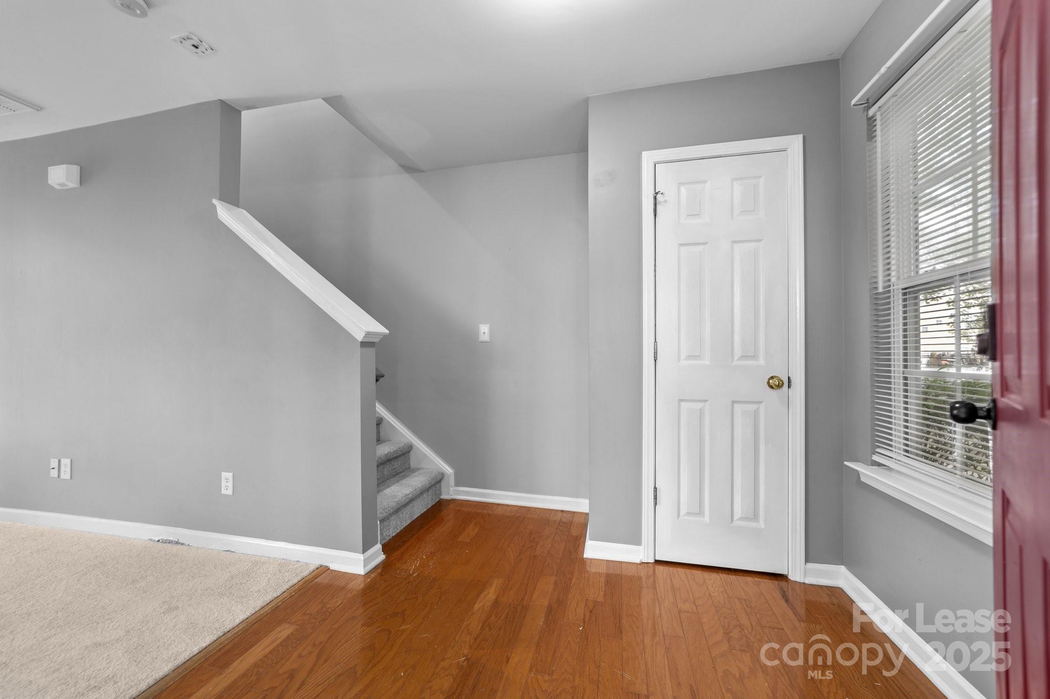 17562 Caldwell Track Drive Cornelius, NC 28031 - Photo 5 of 38 a view of an empty room with wooden floor and stairs