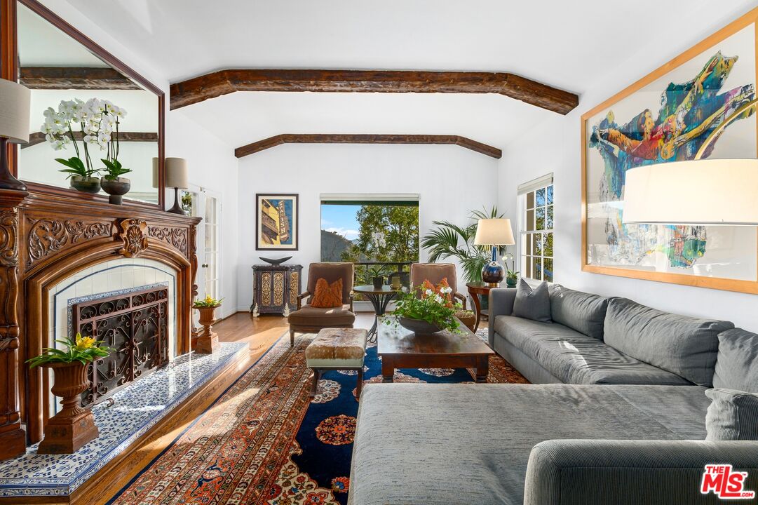 2300 Gardner Place Glendale, CA 91206 - Photo 3 of 20 a living room with furniture a fireplace and a floor to ceiling window