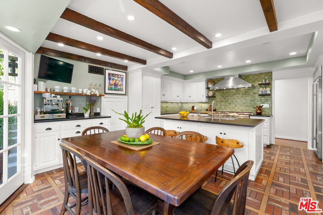 2300 Gardner Place Glendale, CA 91206 - Photo 7 of 20 a dining room with stainless steel appliances granite countertop a table chairs and wooden floor