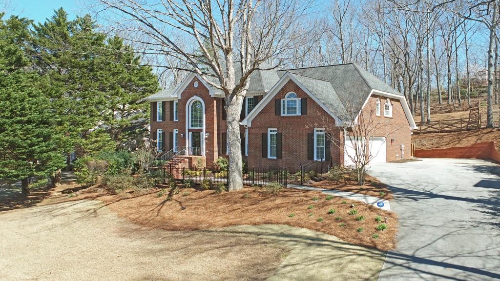 4409 Windsor Oaks Circle Marietta, GA 30066 - Photo 11 of 90 a brick house with tree in front of it